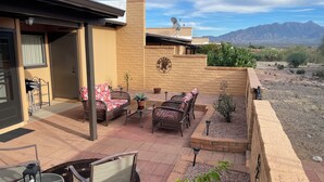A patio with outdoor furniture, a small table, and a chair. - Enjoy Gorgeous Mountain Views w/Privacy & Southwestern Ambiance Inside and Out! (Green Valley)