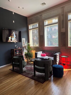 A modern living room with a flat-screen TV, a sofa, and a coffee table.