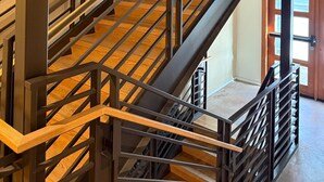 A staircase with wooden steps and metal railings.