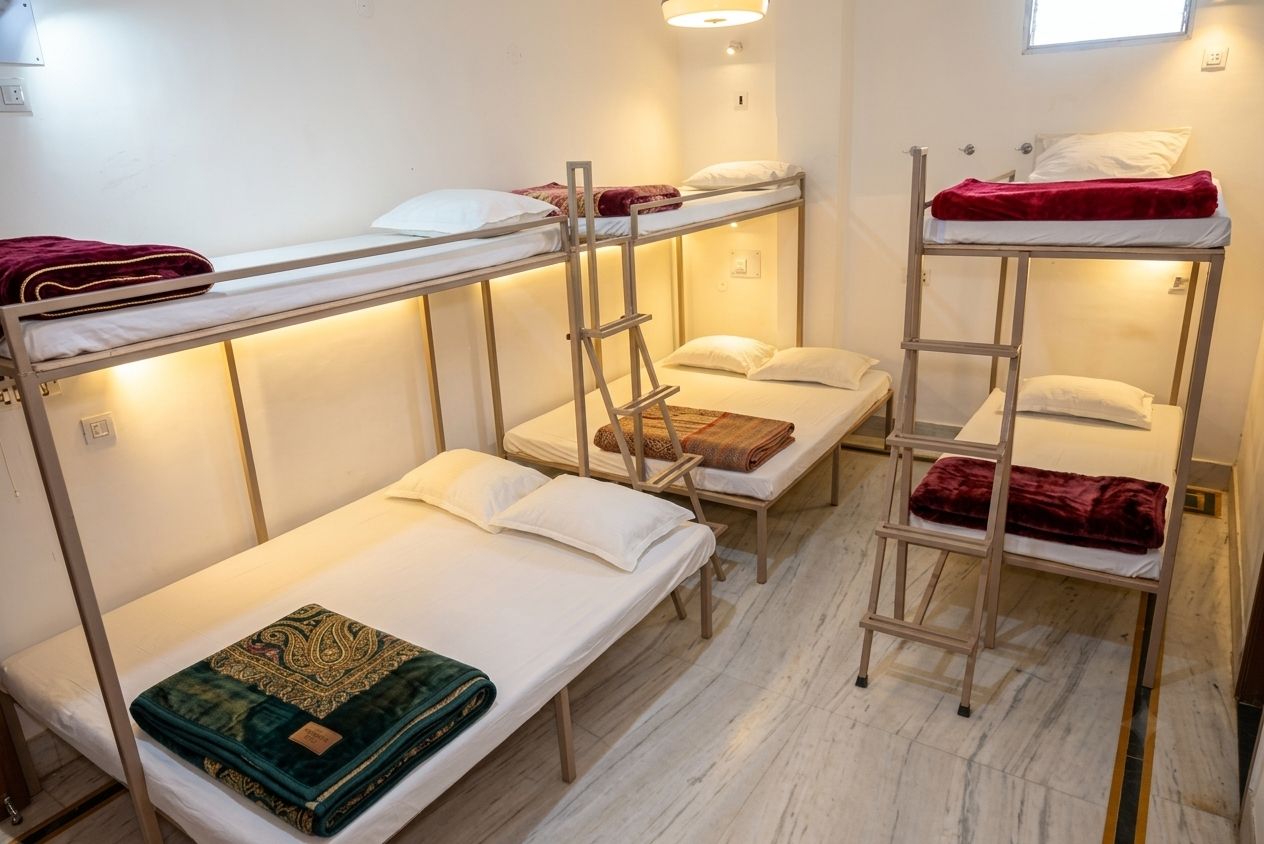 A dormitory room with bunk beds, a ladder, and a window.