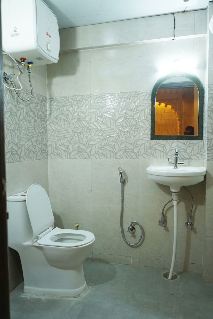 A bathroom with a toilet, a sink, and a shower.