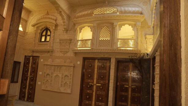 A corridor with ornate doors and architectural details. - Batra Guest House (Varanasi)