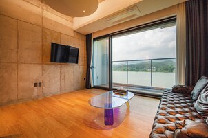 Superior Suite, Balcony, Lake View | Living area | TV