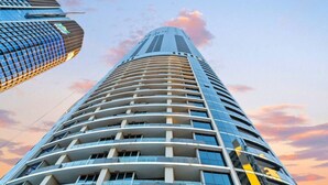 A high-rise building with a curved facade and multiple balconies.