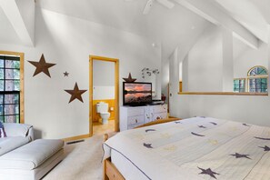 A bedroom with a large bed, a television, and star decorations on the wall. - 27 Circle Four Cabin - AC & 8 SHARC Passes! (Sunriver)