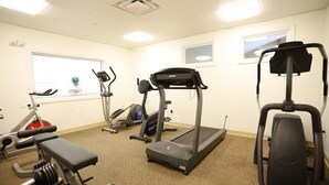 A gym with treadmills, elliptical machines, and weight benches. - Rivergreen 301, Lincoln (Lincoln)