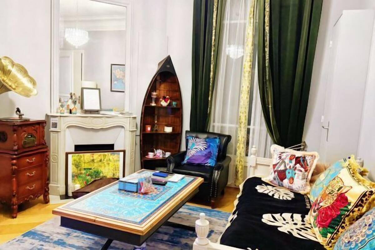 A cozy living room with a fireplace, a bookshelf, and a comfortable sofa.