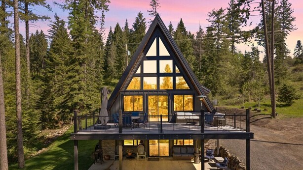 A modern cabin with a large deck, surrounded by a forest. - Lake Views At Rockford Bay - The CDA-frame (Coeur d`Alene)