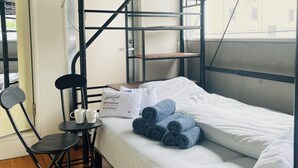 A bunk bed with a desk and chair, a window, and a white pillow with text. - 15min Shinjuku/5min Hatsudai(OperaCityDirect).Quiet,perfect place/Early check-in (Shinjuku City)