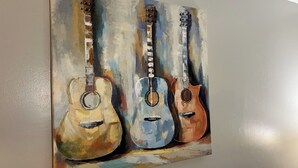 A painting of three guitars on a wall. - Spacious 2-bedroom townhouse-style apartment located in the center of Dothan. (Dothan)