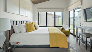 A modern bedroom with a large bed, a desk, and a TV. - Lake Travis Getaway / Pickleball / Grill / Firepit (Lake Travis)