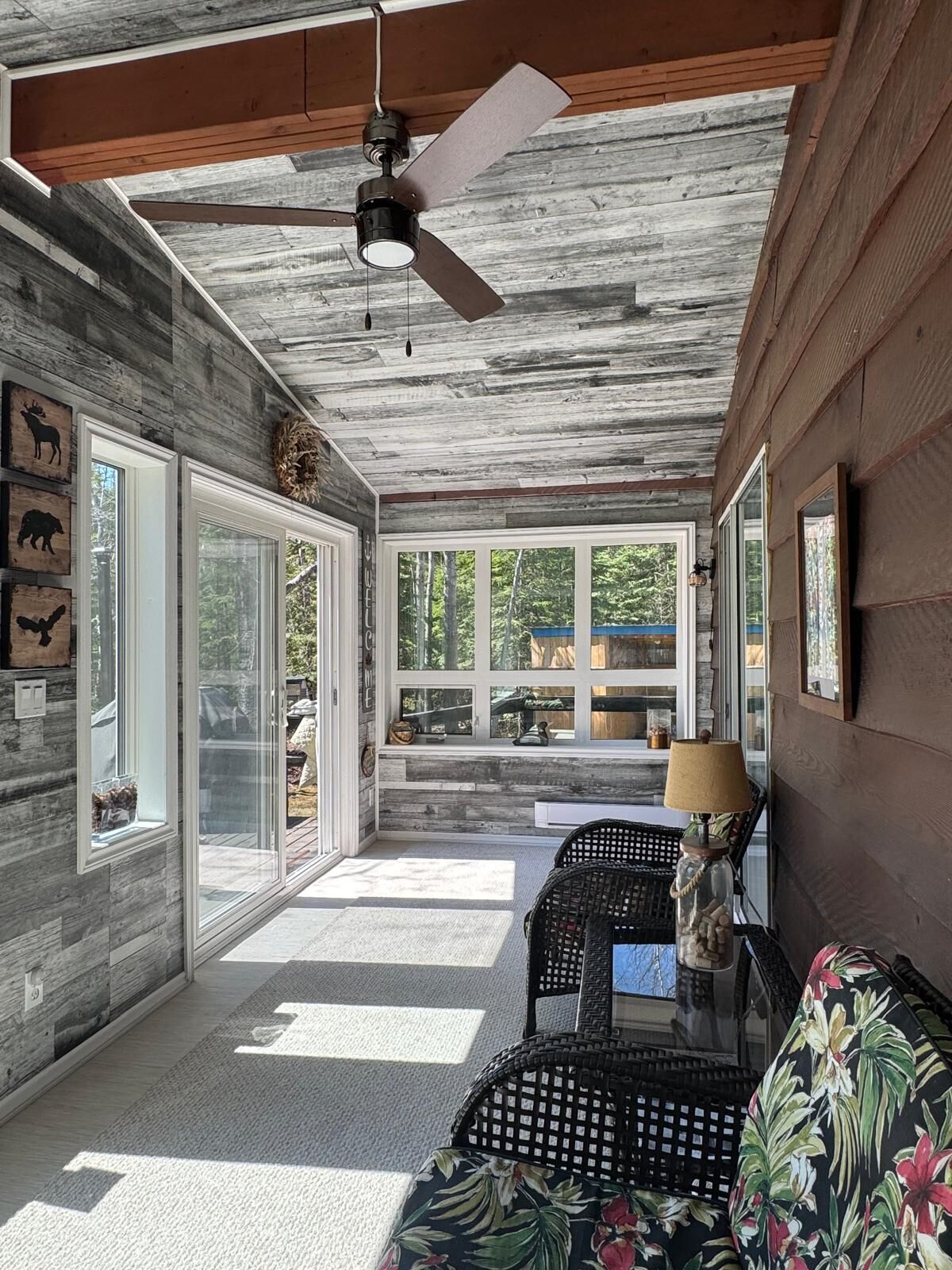 Sunroom with lake and yard views