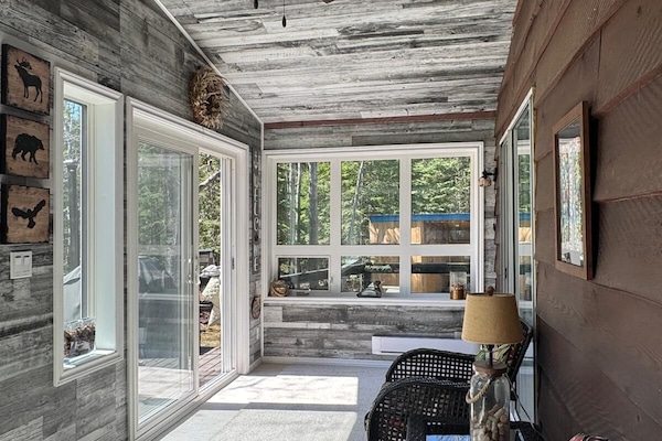 Sunroom with lake and yard views