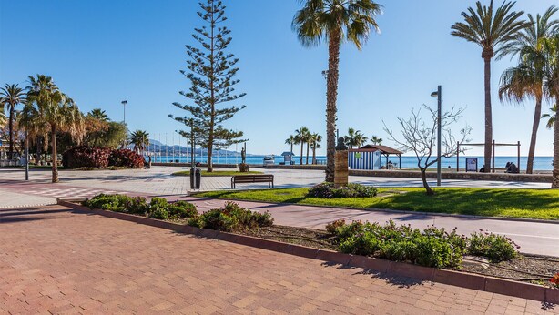 A paved promenade with benches, palm trees, and a view of the sea. - A&N Seafront 2 (Torre del Mar)