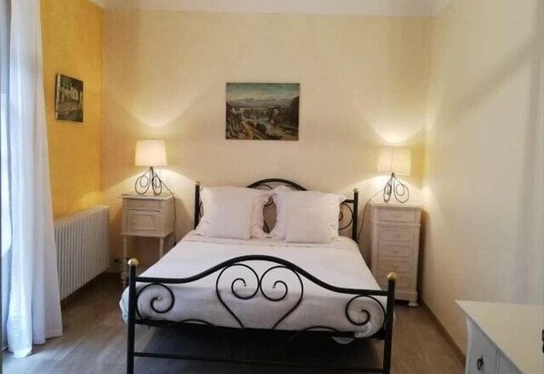 Cozy retreat with a single bed, bedside tables, and a wall-mounted painting.