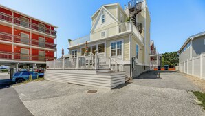 A multi-story building with a balcony and a small porch area. - Steps to Shore: Newly Renovated Dewey Beach Home! (Dewey Beach)
