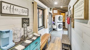 A cozy coffee bar area with a coffee machine, a milk frother, and a sign that reads "Coffee Bar." - Hot Tub + Arcade Table: Spacious Retreat in Lead (Lead)