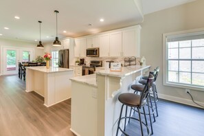 Prepare meals and dine in comfort at the central island with bar stools.