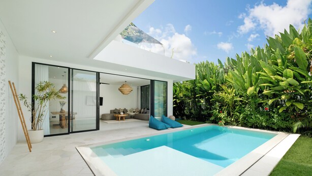 A modern house with a swimming pool, glass doors, and a lush garden. - Loona Palm Villas by Villa Finder (Canggu)
