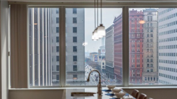 A dining area with a view of a cityscape through large windows.
