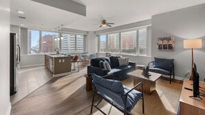 A modern apartment with a kitchen, living area, and dining space.