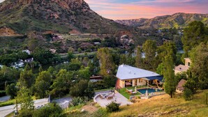 A house with a swimming pool, surrounded by trees and hills. - Private Pool | 2 Firepits | Peloton | Mtn Views | The Lake House at Malibu (Agoura Hills)