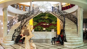 A grand lobby with a marble staircase, a reception desk, and a decorative archway. - Eco Therma Village Spa & Sport (Balchik)