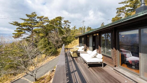 A modern cabin with a deck, outdoor seating, and large windows. - SHODOSHIMA PRIVATE CAMP SITE (Shodoshima)