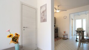 A modern kitchen with a microwave, oven, and coffee maker on a small table. - Stunning  villa for 6 people with A/C, WIFI, TV, terrace and pets allowed (Lido Degli Estensi)