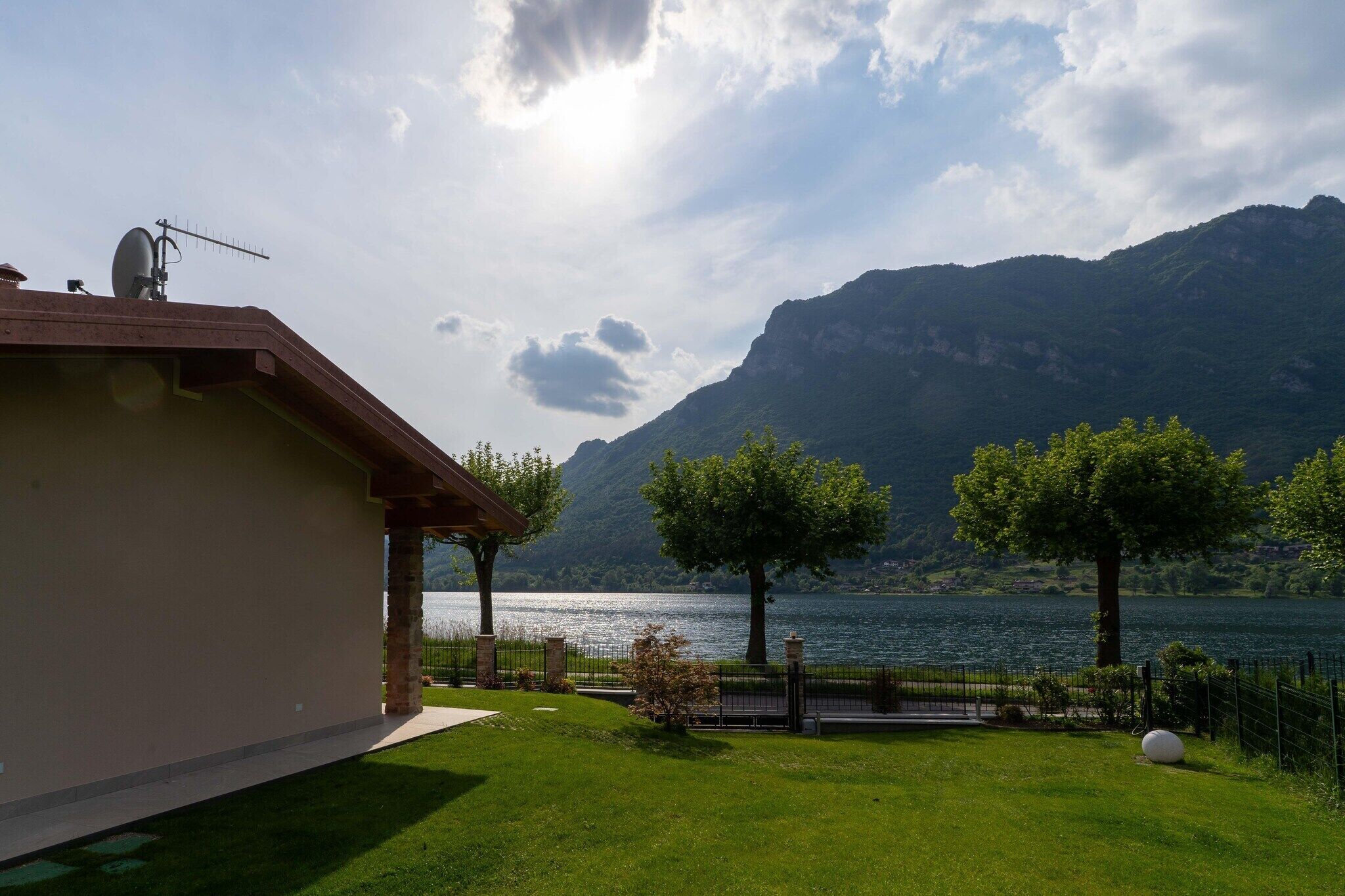 A house with a view of a lake and mountains.