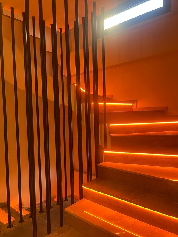 A staircase with warm lighting and metal railings.