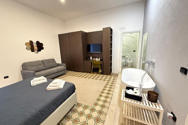 Deluxe Quadruple Room, Balcony, City View | In-room safe, blackout drapes, iron/ironing board, free WiFi