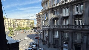 A street view with a building featuring multiple balconies and a large sign for DAMARONT. - LA PIAZZA SUITE (Naples)
