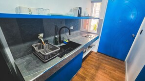 Full-size fridge, microwave, stovetop, cookware/dishes/utensils