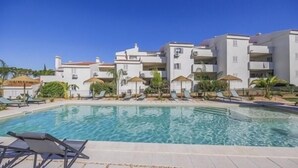 A hotel with a swimming pool, sun loungers, and umbrellas. - 2 bed renovated apartment in vale do lobo Algarve (Loulé)