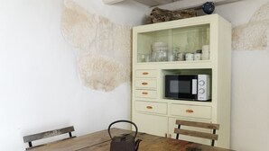 A kitchen with a wooden table, a kettle, and a microwave. - Dimora Upupa by Wonderful Italy (Ostuni)