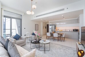 Luxury Apartment, Beach View | Living area | 65-inch Smart TV with satellite channels