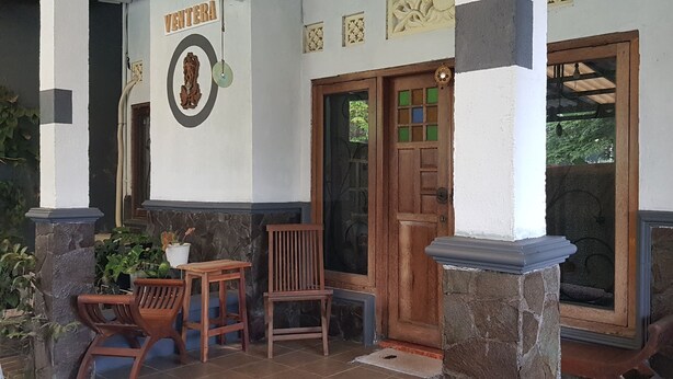 A building entrance with a wooden door, a stone pillar, and a sign that reads "VENTERA". - Ventera Homestay (Kalasan)