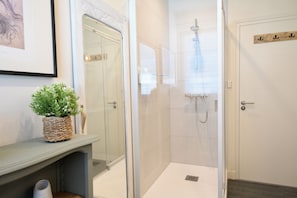 Shower, hair dryer, towels, toilet paper