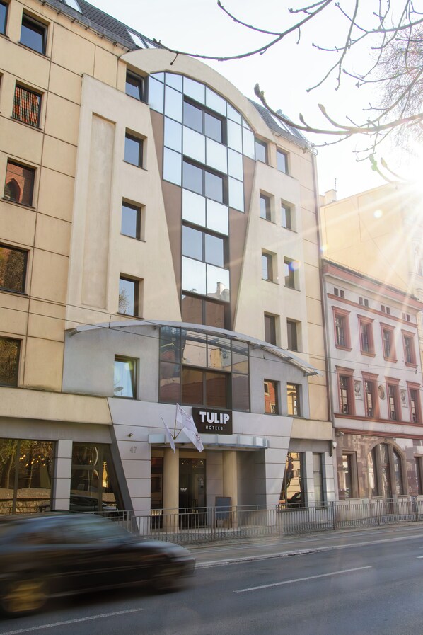 A hotel with a modern design, featuring a prominent glass facade and a sign that reads "TULIP HOTELS". - Tulip Hotels - Wroclaw Centre (Wroclaw)