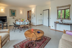 Apartment, City View | Living area | 32-inch flat-screen TV with cable channels
