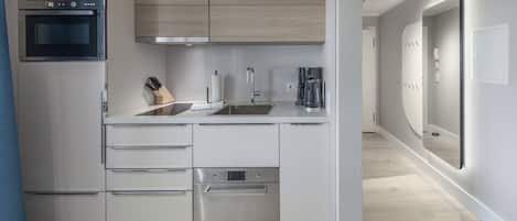A modern kitchen with built-in appliances, a sink, and a countertop.