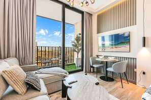 TV - Stylish Studio in JVC with Pool, Gym, Balcony & Modern Comforts (JVC)