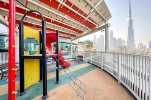 Children’s area - Spacious 2BR with Balcony – Stunning Burj Views & Steps from Bay Avenue Park (Business Bay)