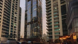 A swimming pool with a modern design, surrounded by high-rise buildings.