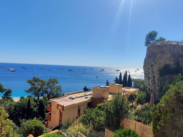 A coastal view with buildings and a cliff overlooking the sea.