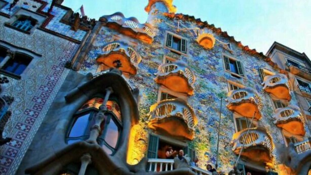 A building with unique architecture featuring balconies and ornate designs.