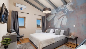 A bedroom with a bed, bedside table, desk, chair, potted plant, and a large window. - Sun  Spalato Villa Oblica (Jadruhi)