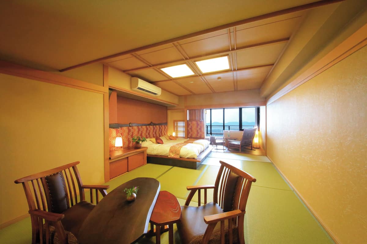 Ein traditioneller japanischer Raum mit Tatami-Böden, einem niedrigen Tisch und Holzmöbeln.
