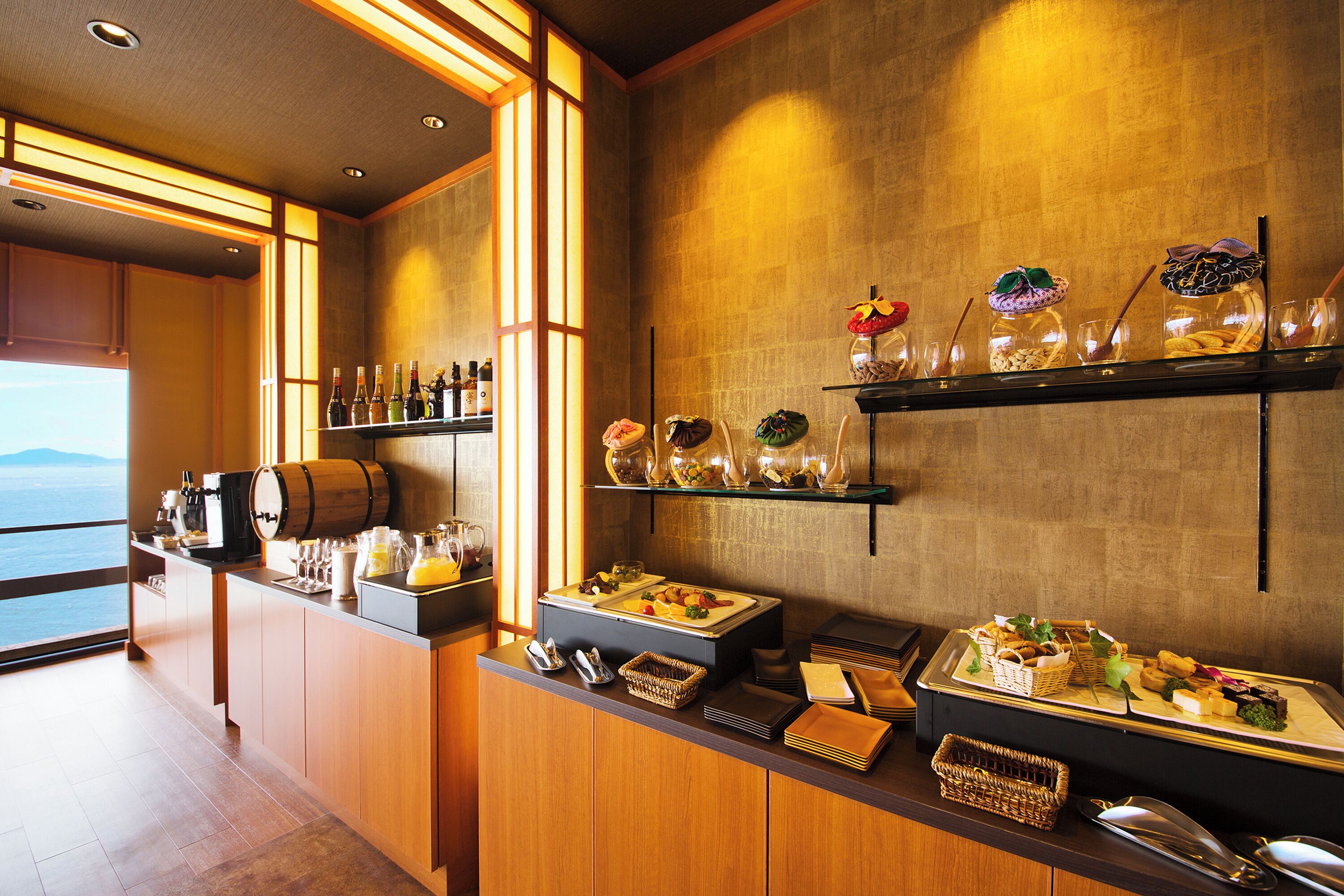 A buffet setup with various food items, a coffee station, and a wine selection.
